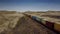 Almaty Region, Kazakhstan - October 16, 2018: Railway container train moving along the steppe in cloudy weather. The