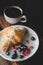 Almond croissant, berries and cup of coffee