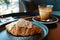 almond croissant butter with dirty coffee background