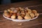 Almond and Hazelnut with shell in pink dish on a tablet wood