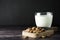 Almond milk - alternative to clasic milk. A glass with almond milk and almond nuts. Dark food photo with copy space. Healthy,