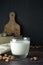 Almond milk - alternative to clasic milk. A glass with almond milk and almond nuts. Dark food photo with copy space. Healthy,