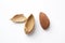 The almond next to the shell on a white background. A nut with a cracked shell. Peeled almonds.