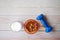 almond nut in a bowl, milk and dumbbell on table