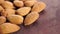 Almond nuts in a rustic style on a brown board. Macro. Rotation.