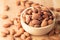 Almond seeds in a bowl wood on table wooden brown