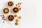 Almond walnut hazelnut chocolate small tarts on a white background, space for text