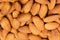 Almonds background. Pile of selected almonds close-up.