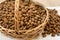 Almonds, in a basket, on a wooden table.