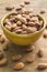 Almonds in bowl on wooden background