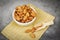 Almonds bowl and wooden scoop on sack on dark stone table background / Close up almond nuts natural protein food and for snack