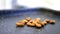 Almonds dropping on a black tray with blurry background