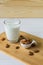 almonds and glass with almond milk on wooden background