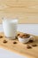 almonds and glass with almond milk on wooden background