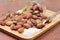 Almonds nuts with salt on wood background.