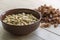 Almonds peeled, ceramic bowl, vegetarian food, wooden background,