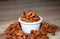 Almonds seed on in porcelain bolw on wooden table