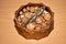Almonds, walnuts and hazelnuts in wooden bowls on wooden background