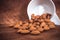 Almonds in a white cup on wooden background