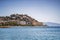 Almunecar cityscape - houses on steep hills by the coast and busy beach, Spain