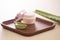 Aloe vera cosmetic cream on wooden tray with aloe leave on light background
