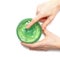 Aloe vera gel in a jar in a female hand on a white background, top view. Aloe is a natural remedy for sunburn