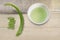 Aloe Vera medicinal plant pieces cut juice in Cup on wooden background