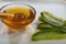 Aloe Vera slices with juice and honey wood spoon on white plate, skin care spa