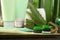 Aloe vera toothpaste, brushes, green leaves and care products on grey table, closeup