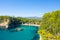 Alonaki Fanariou sandy beach and its green rocky cliffs , in Europe, Greece, Epirus, towards Igoumenitsa, by the Ionian sea, in