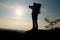 Alone adult man backpacker at sunrise at open view on mountain peak