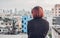 Alone asian woman sitting at rooftop of building see cityscape v