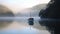 alone boat gliding on a misty lake