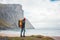 Alone brave male tourist standing in front of ord sea and great mountain rock