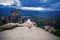 Alone female in the white plaid on the edge of the rock look on the monasteries of Meteora. Female on the rock and monasteries of