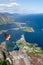 Alone happy woman hiker enjoys the view on cliff edge of lofoten islands, in Norway, Reinebringen