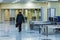 The alone man from the back in the airport or railway station going to the registration hall