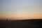 Alone man on the beach with silhouette of a dune