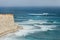 Alone man enjoying the strong surf on the cliff near the Marsaxlokk , Malta