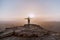 Alone man in israel negev desert admires the view of sunrise. Young male person stands on the edge of the cliff