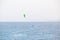 Alone man kitesurfing on sea waves