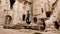 Alone man standing at the middle of the ancient Gumusler Monastery in Cappadocia