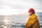 Alone man traveling on ship and looking at sunset sea and foggy mountain on skyline