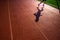 Alone runner train on the track, silhouette photo, red Track and field background