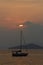 Alone sailboat at sunset.