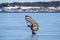 An alone surfer ice surfing on the frosen sea on a sunny spring day