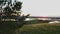 Alone woman meditating on the green hill above the highway at early sunset