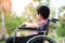 Alone young disabled man on wheelchair in the park, Patient is relaxing in garden decorations of the hospital feeling of missing