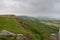 Along the front of Curbar Edge and Baslow Edge in Derbyshire on a misty, grey summer day