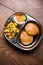 Aloo Fry OR Bombay potatoes and puri/Poori in a stainless steel oval plate